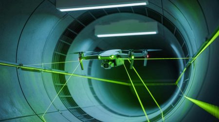 Illustration of a drone navigating a ventilation duct using AI and laser technology.